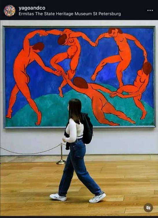 Museum visitor viewing a colorful fine art painting